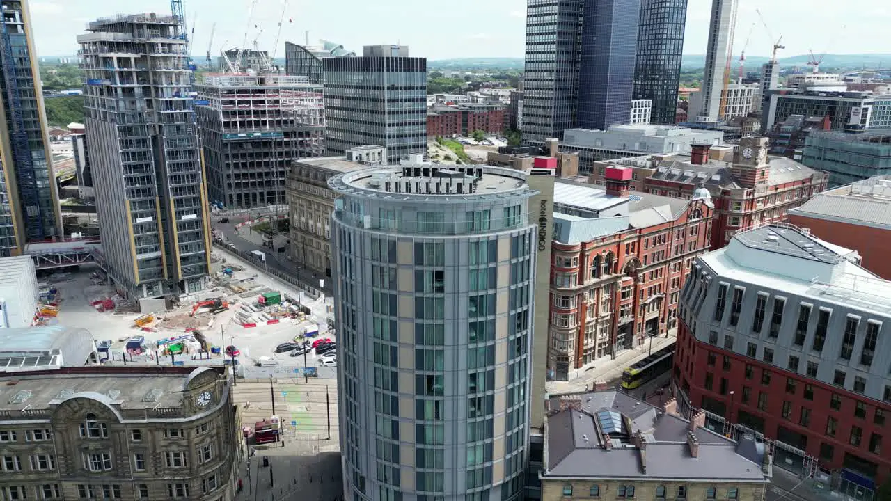 Aerial drone flight around tall towers in Manchester City Centre currently under development with the Co-operative Building in the background