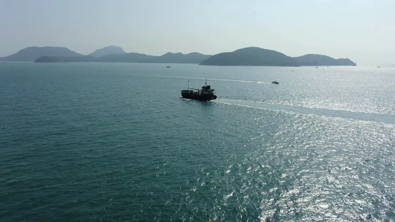 Aerial footage of a Cargo ship cruising in Hong Kong bay