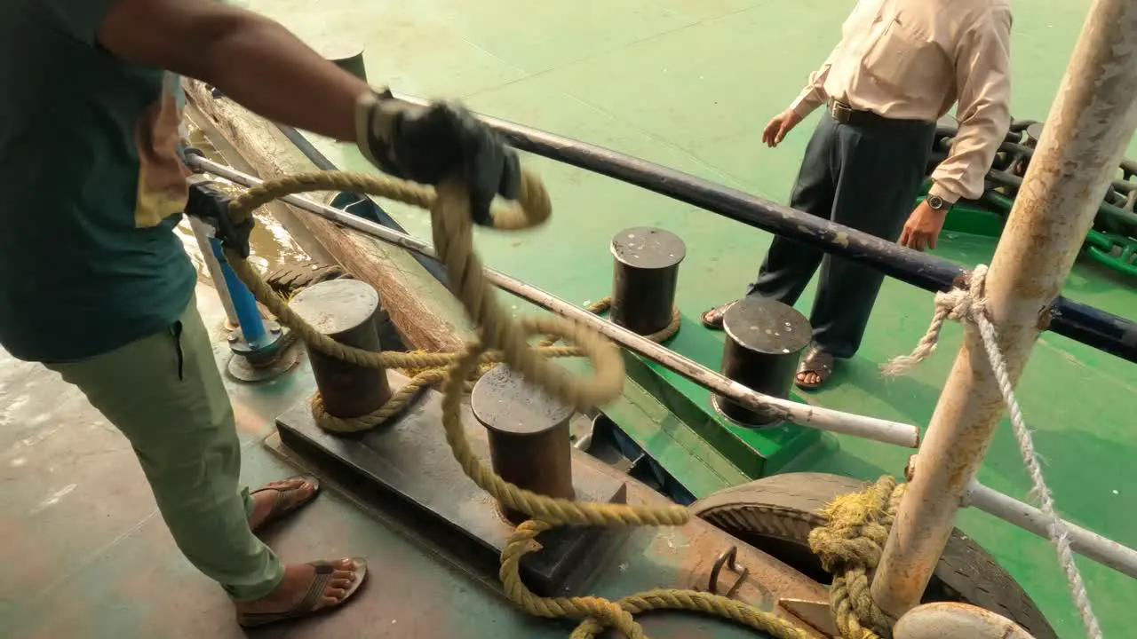 A boat man is docking the ferry to the jetty as people get down at the Belur Math Jetty in Kolkata