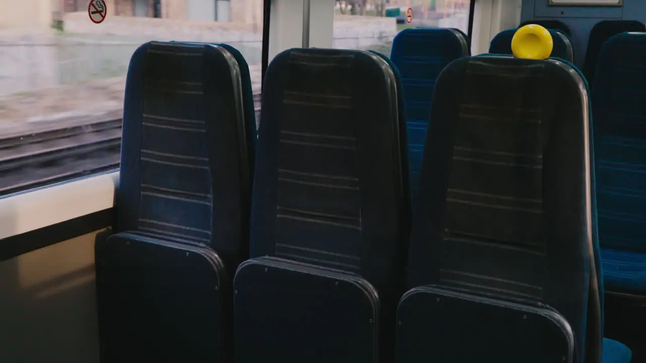 Empty seats inside train travelling through suburban town in England