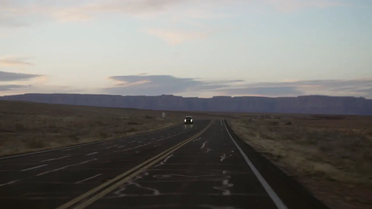 Driving past a truck at sunset in the southwest desert