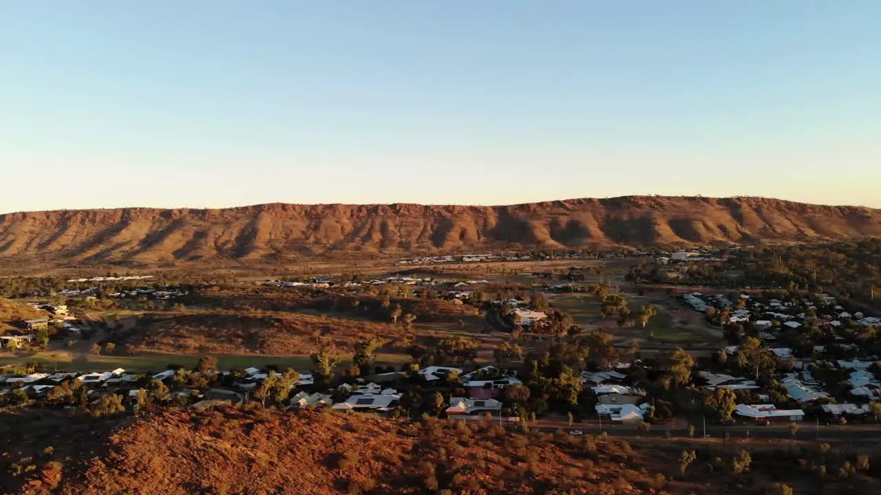 Left Trucking Drone Shot of the mountains and town in Alice Springs Australia