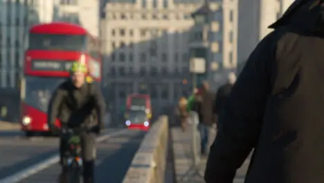 Pedestrians And Buses Crossing London Bridge Defocused