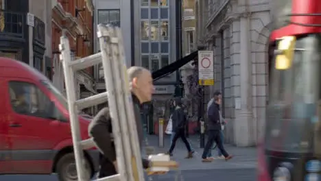 London Bus Passes by Pedestrians 