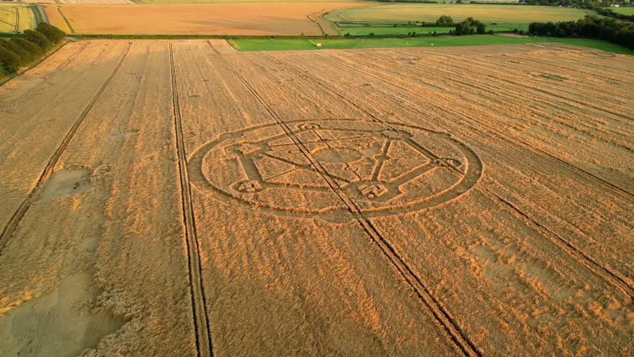 Fortnite molecular atom crop circle design sunset harvest meadow aerial drone view in Wiltshire push in to Birdseye