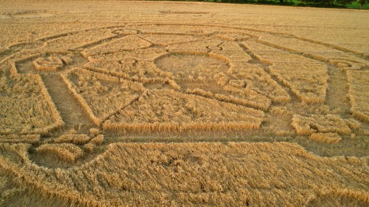 Mysterious Fortnite game atom crop circle pattern sunset farmland wheat field aerial view in Uffcot low reverse rising