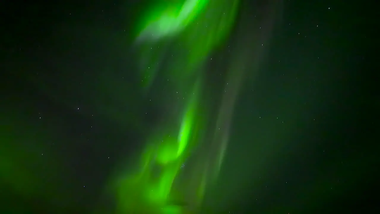 Green Aurora Borealis In The Night Sky With Stars