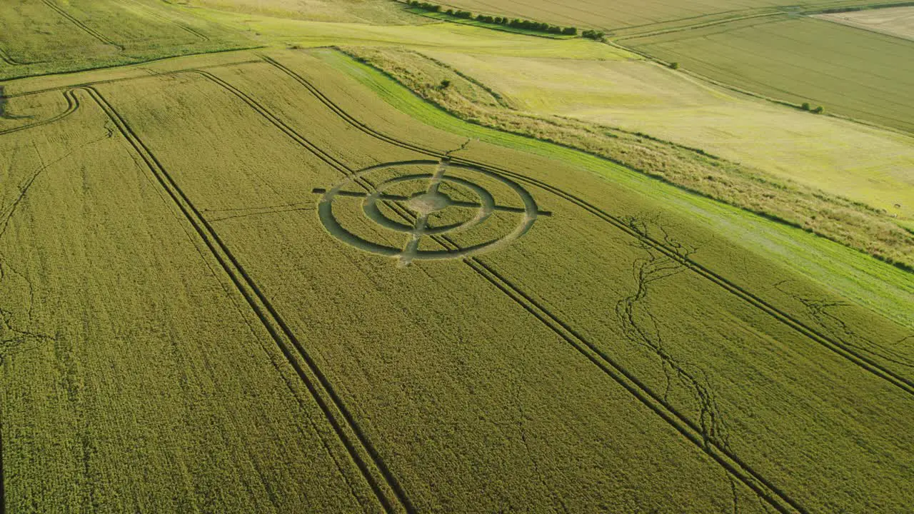 Hackpen hill strange wheat field crop circle design in green harvest farmland aerial view left orbit