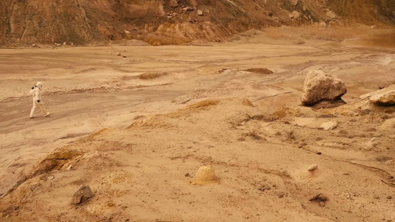 Spectacular panoramic shot capturing an astronaut in full gear exploring a deserted planet with red soil and rocky formations