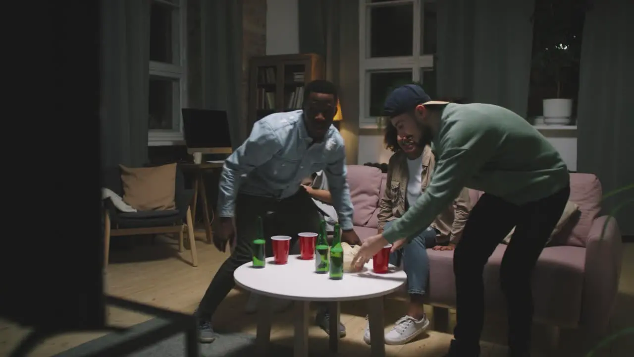 Four Friends Come To The Living Room And Sit On The Couch To Watch Tv