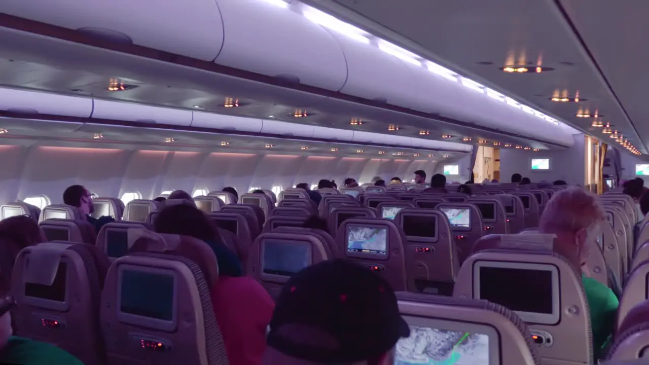 Night Interior of Commercial Airplane with passengers on seats