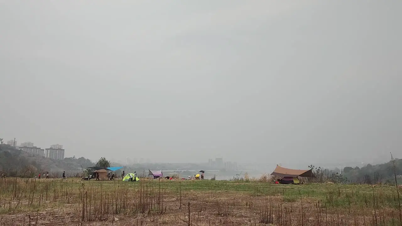 People go camping on the edge of the city on holidays