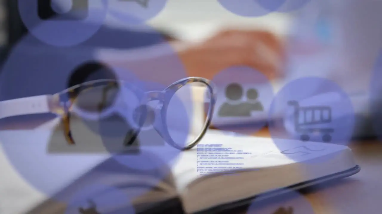 Animation of technology icons over glasses and open book