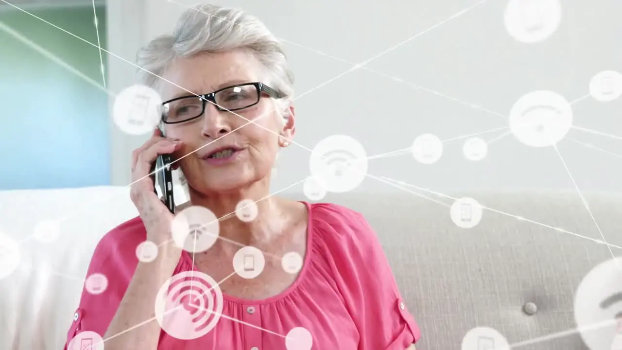 Animation of technology icons connecting with lines over senior caucasian woman talking on cellphone