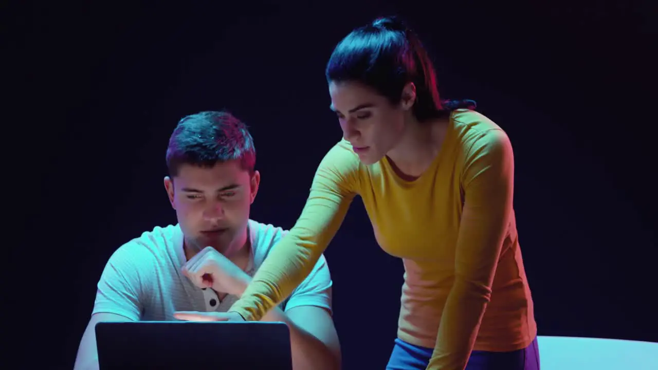 Man and woman working on laptop