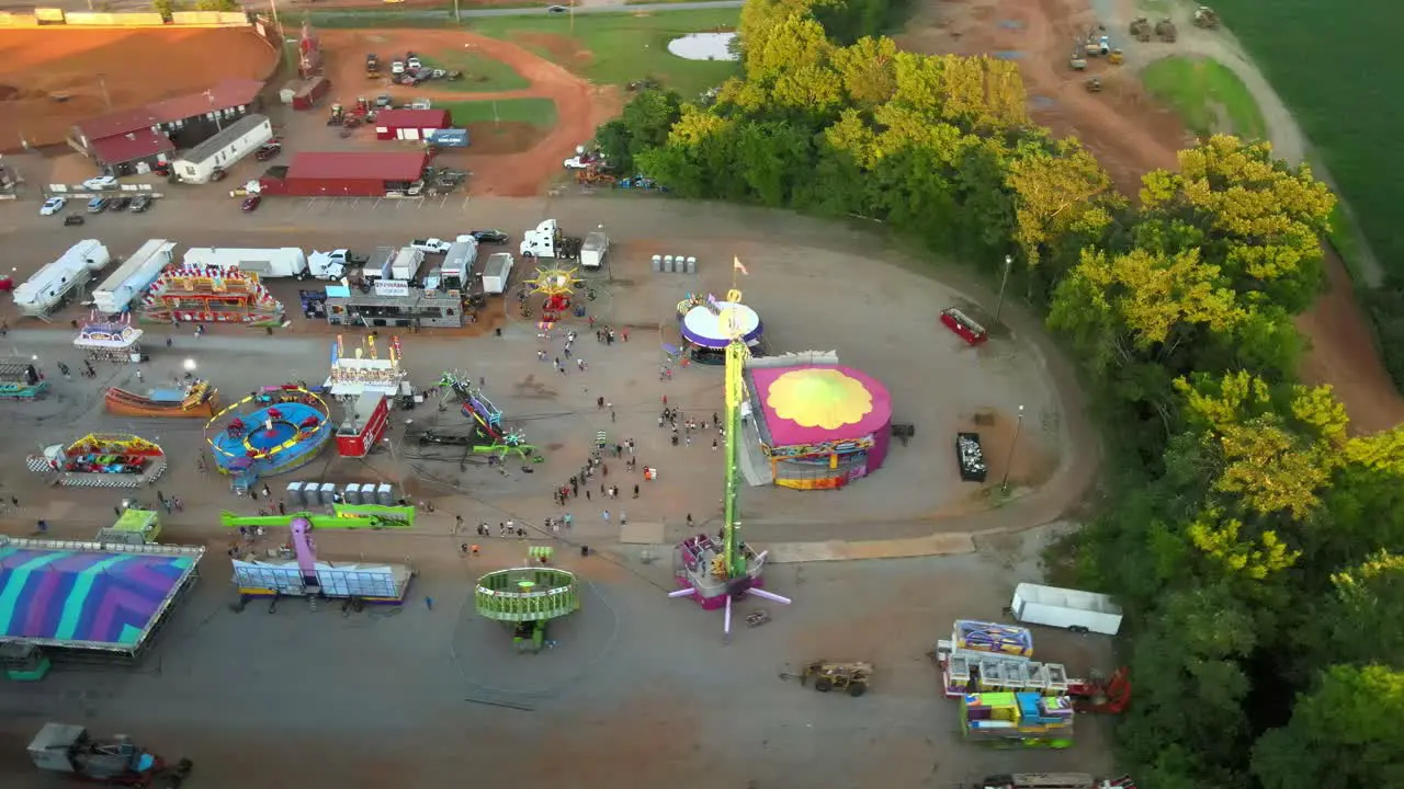 Aerial orbit of a small town carnival and it's attractions