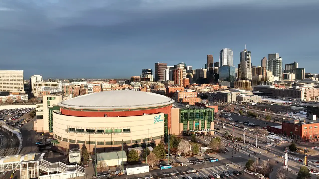 Aerial pullback view of Ball Arena and City of Denver buildings in background