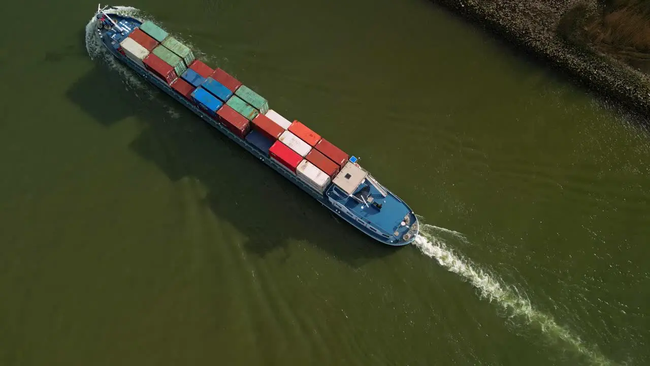 Top down aerial view of a huge container ship navigating through the canals of Zwijndrecht The Netherlands