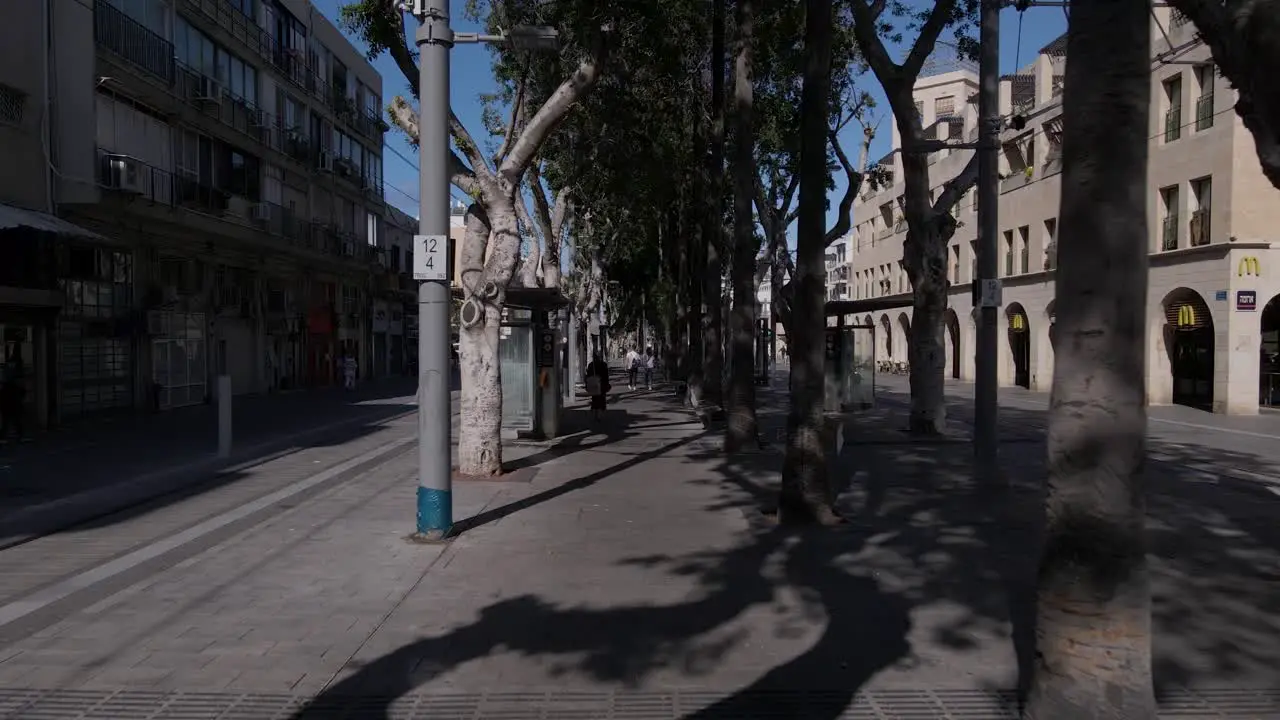 Pedestrians walking in the city between light rail stations walking POV