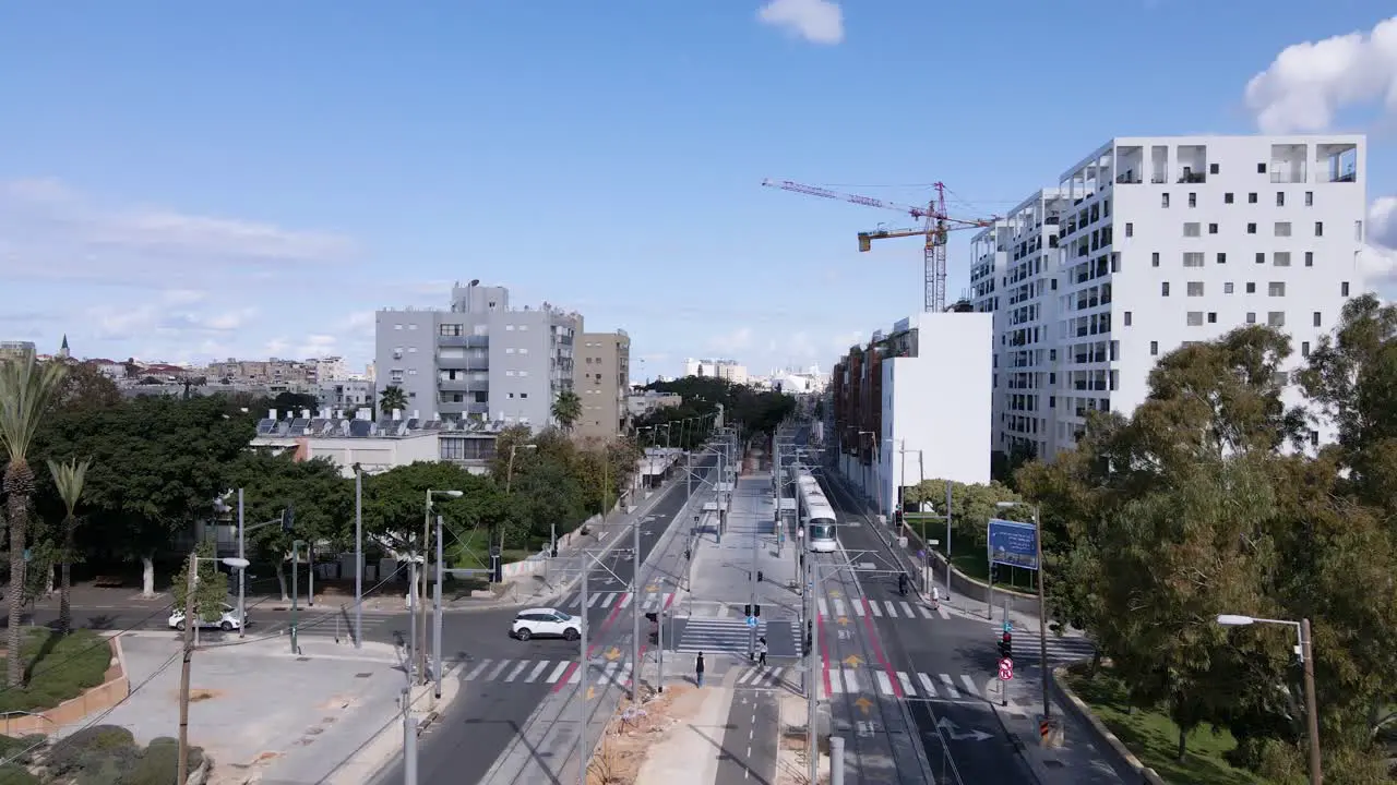 Tram leaving light rail station in the city aerial view