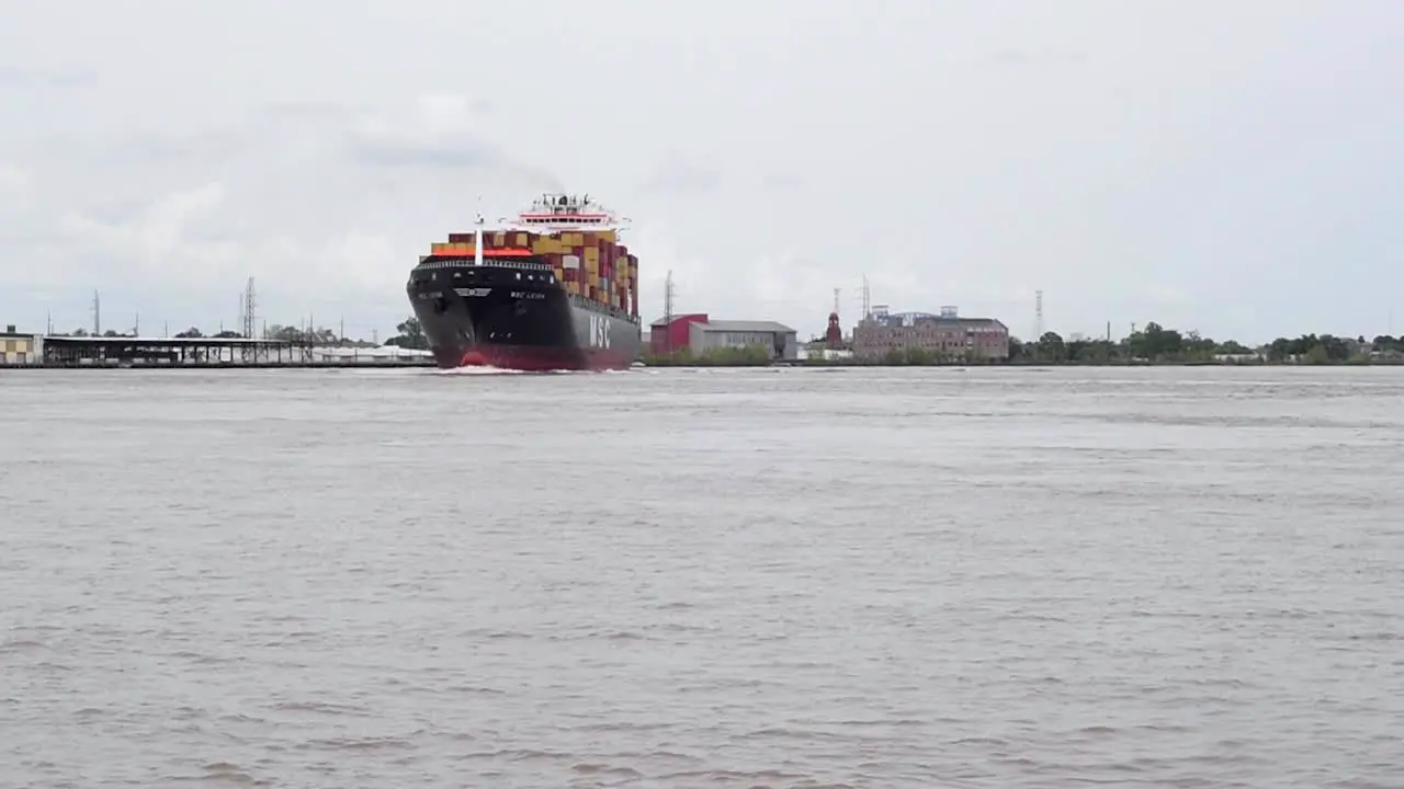 A fully loaded container ship maneuvers the big bend in the Mississippi River at New Orleans Louisiana