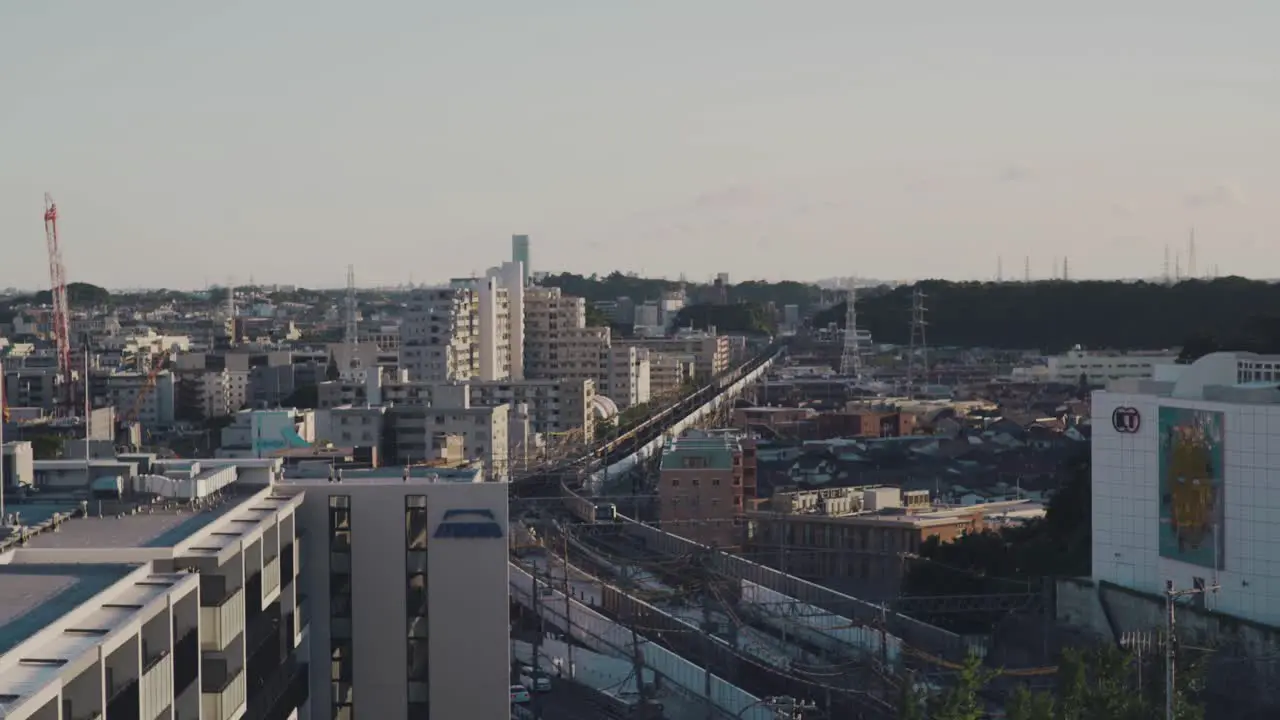 Train Approaching On The Railway With Cityscape View Of Yokohama In Japan high angle shot