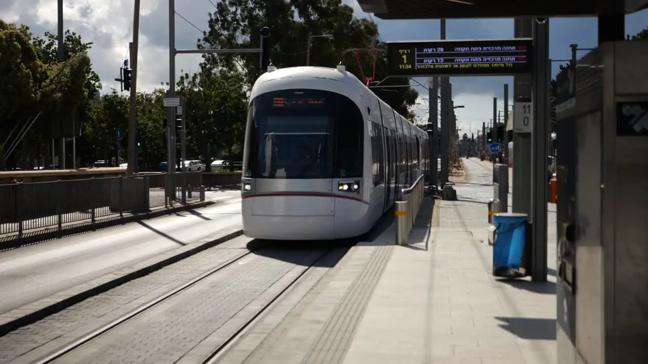 Public transportation tram arriving at train station front view