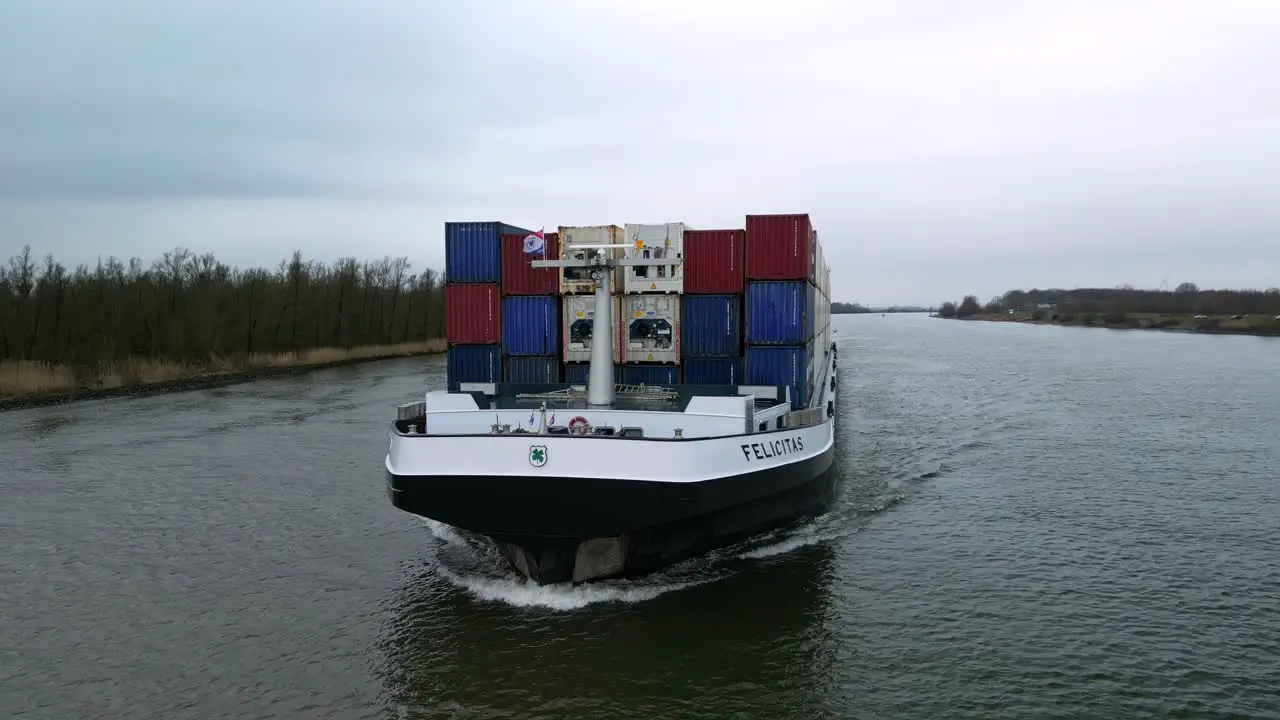 Aerial view front of the containership navigating through the canals of Zwijndrecht The Netherlands