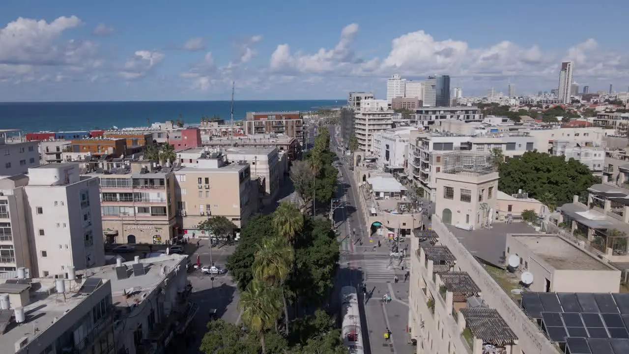 Tram driving through suburban Tel Aviv aerial establishing shot