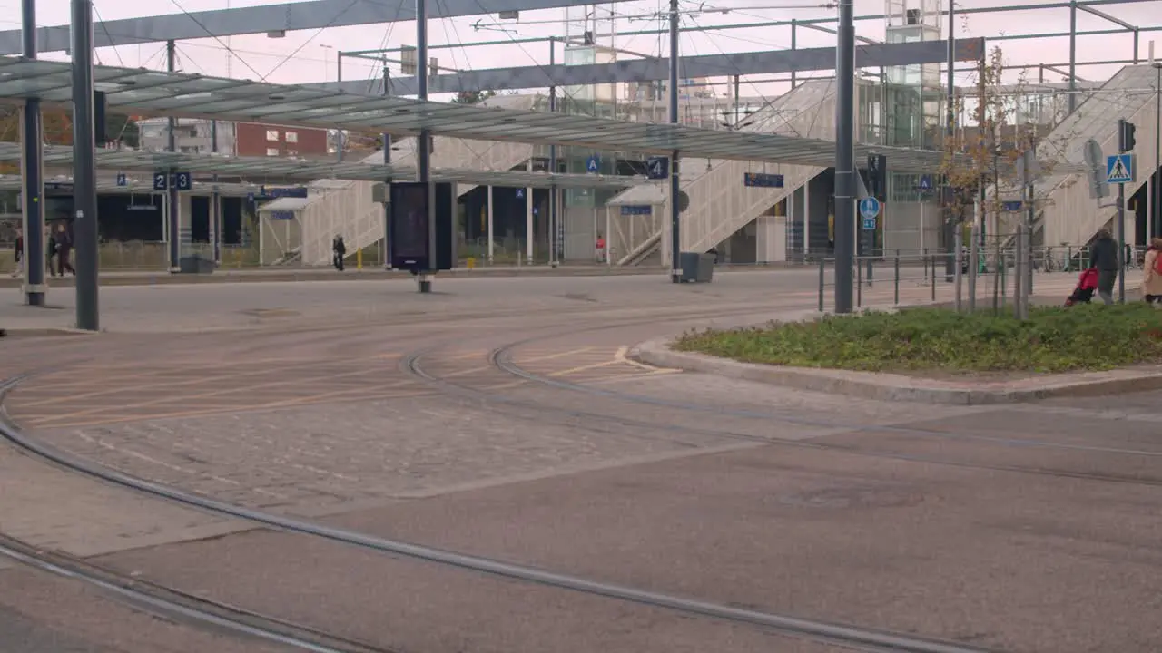 Transit bus car drive on Helsinki street past elevated train tracks