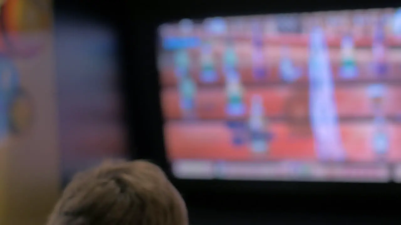 Child entertaining with arcade machine