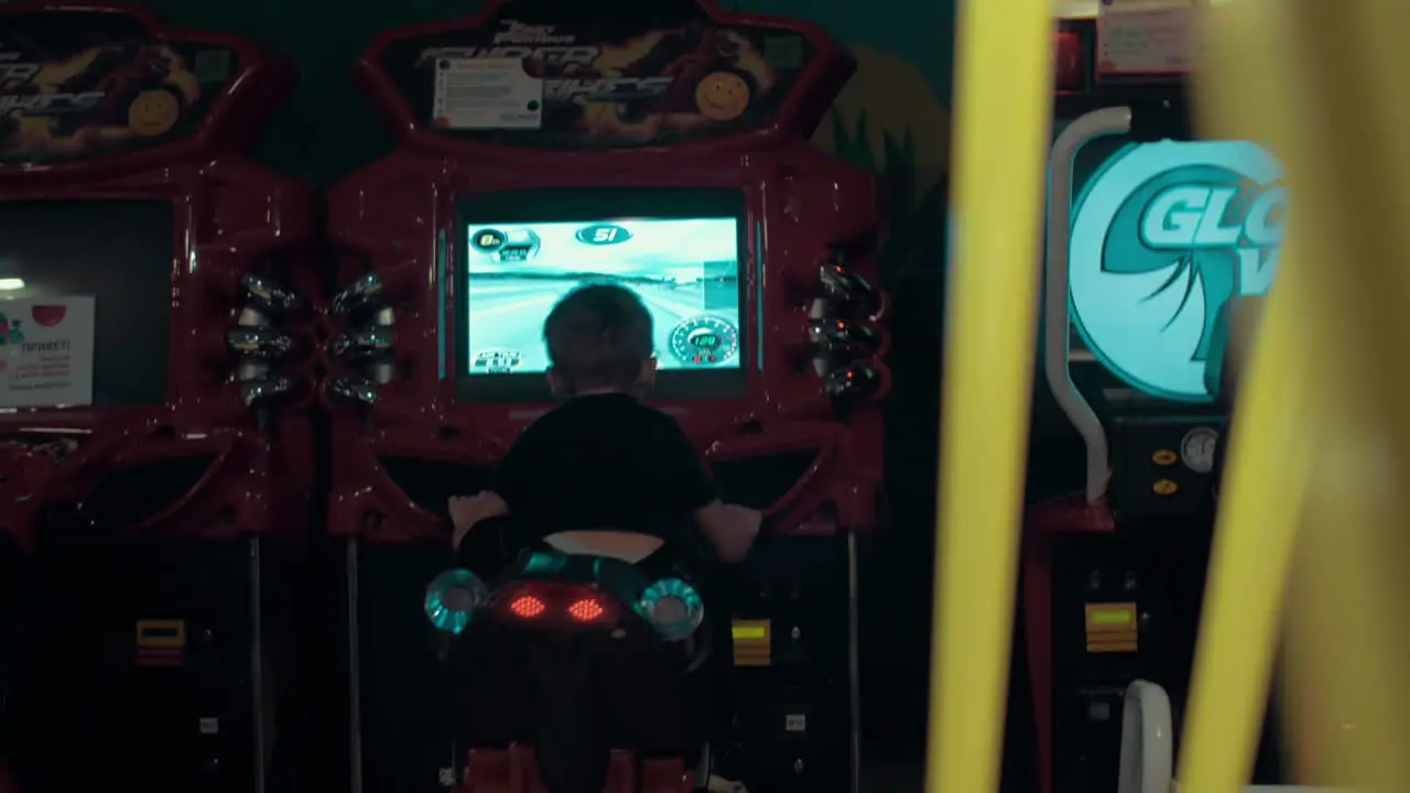 Child playing on racing simulator