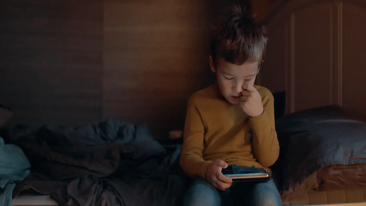 Kid in bedroom browsing web on smart phone