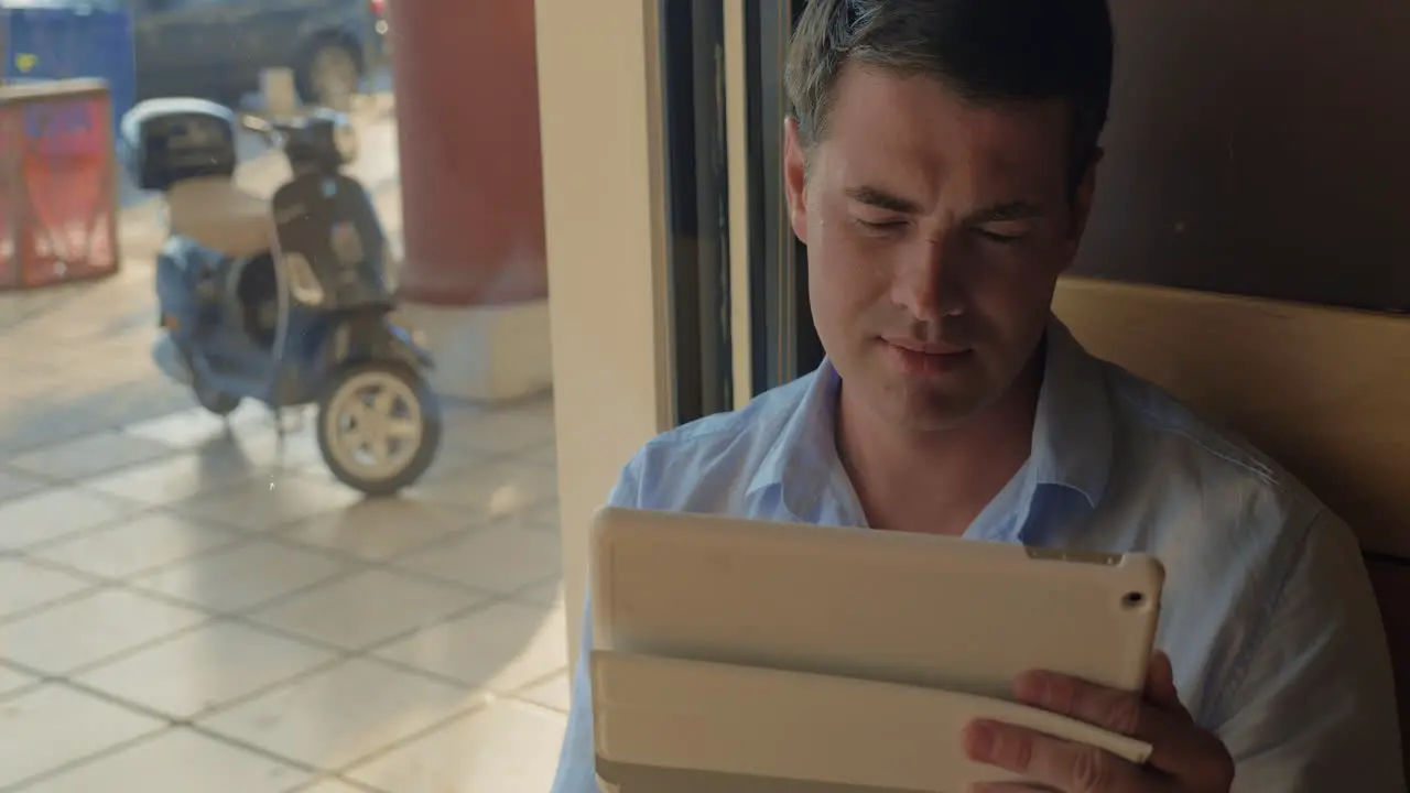 Man working with tablet PC in cafe