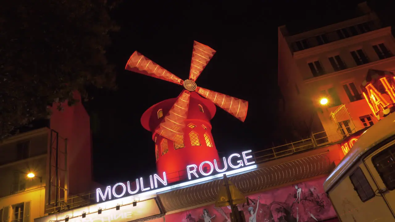 Illuminated Moulin Rouge in Paris at night