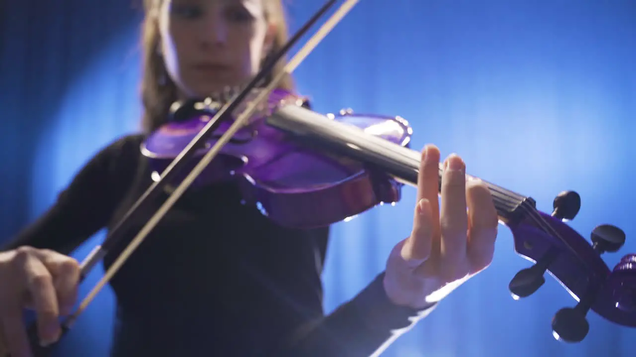 Close-up of musician playing violin on stage