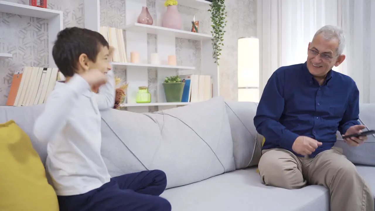 Father and son dancing at home