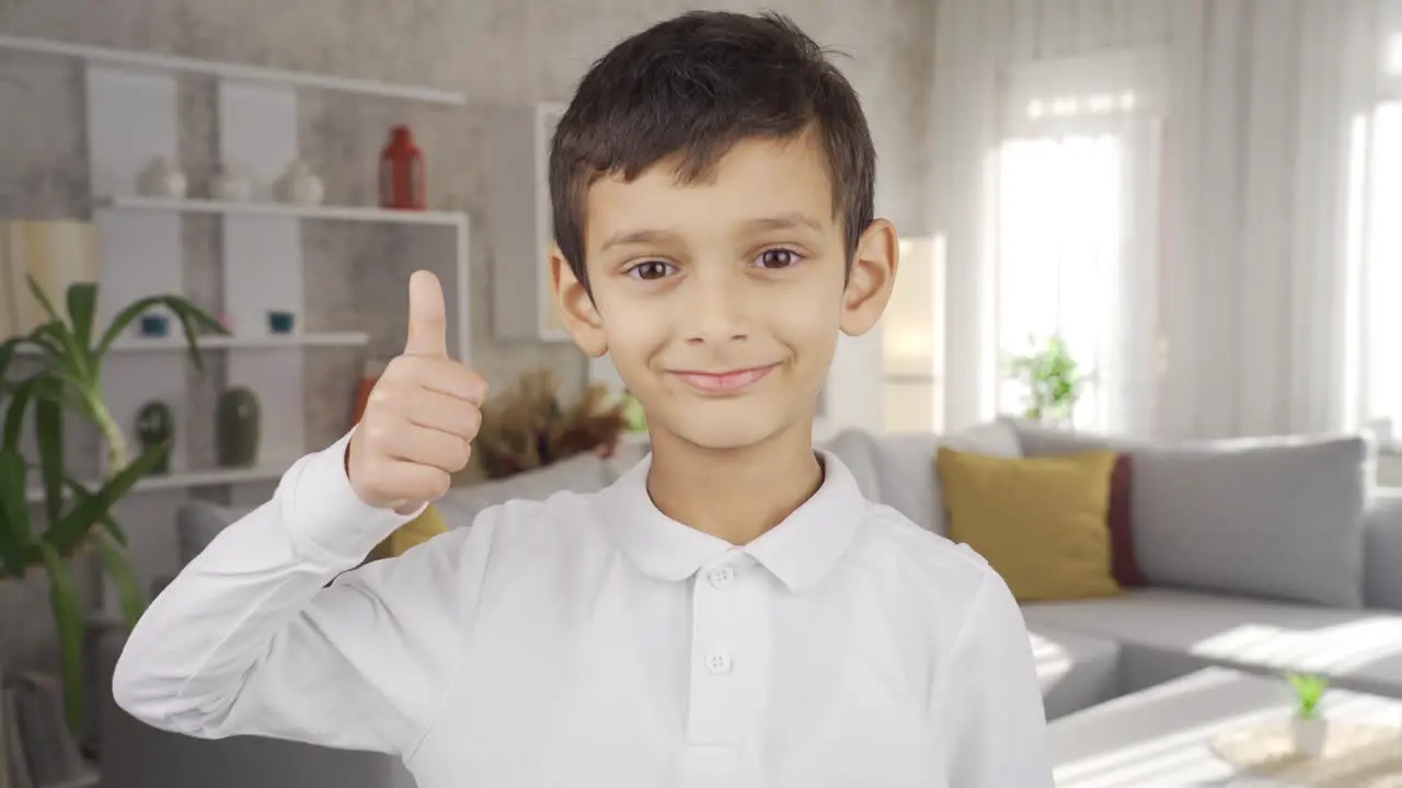 Boy doing check mark looking at camera