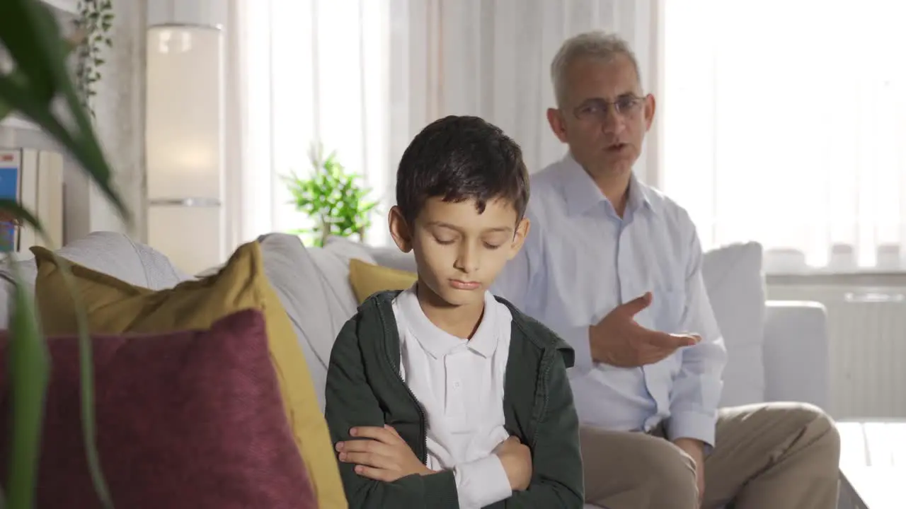 Nervous father shouting at home and scolding his son