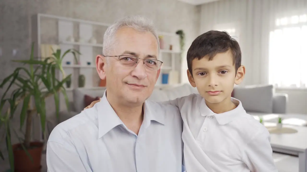 Father and son looking at camera and smiling