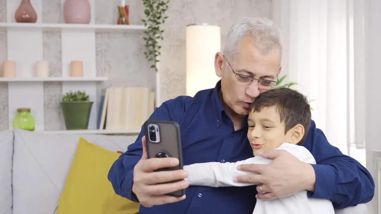 Father and son video chat on the phone together