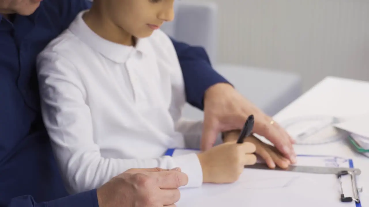 The father is trying to work and play at the same time with the child at home