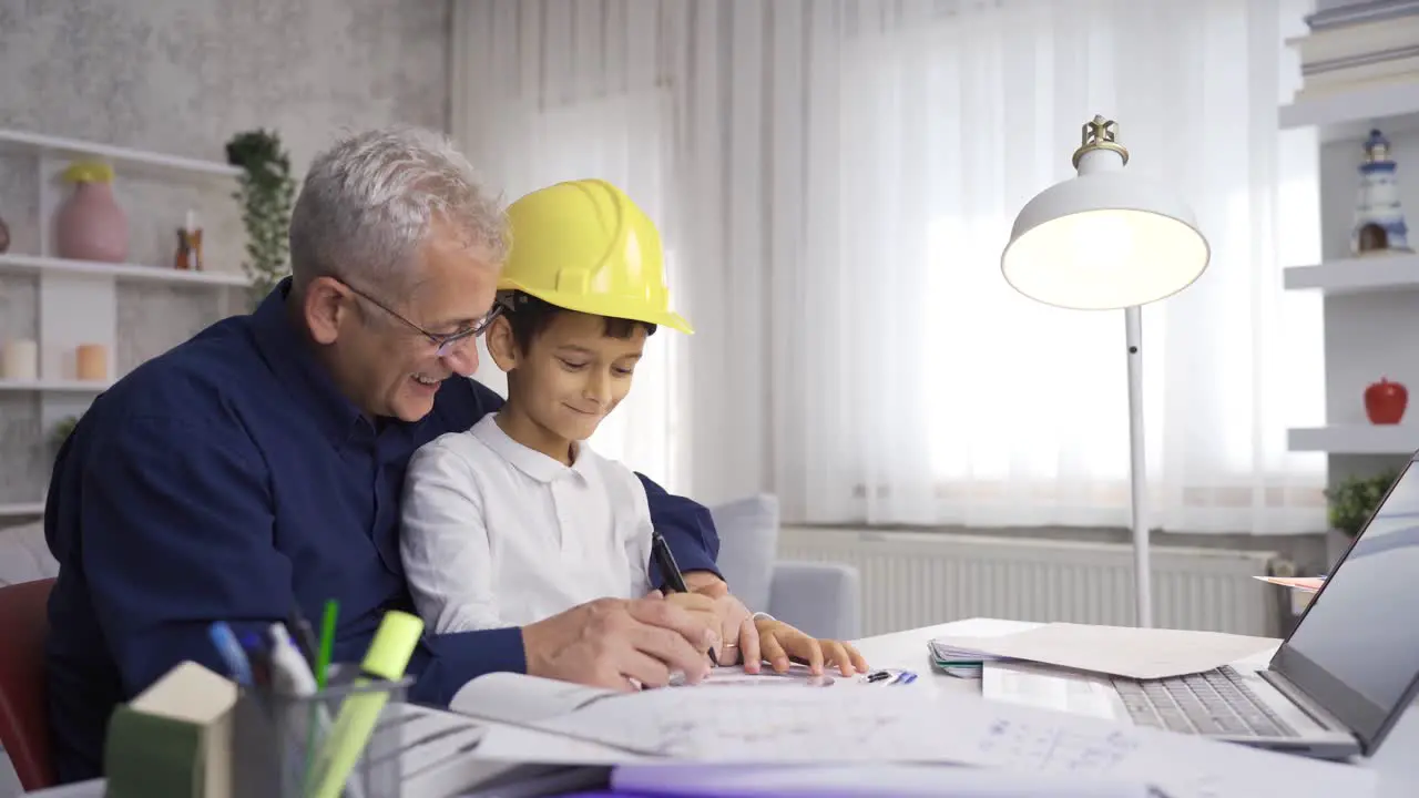 Engineer father works at home with his son