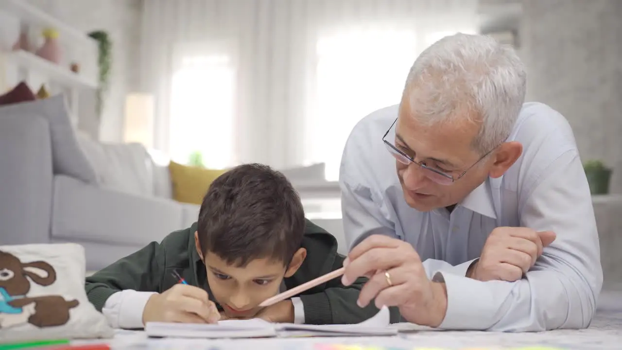 Positive father loves his son and helps him with his homework