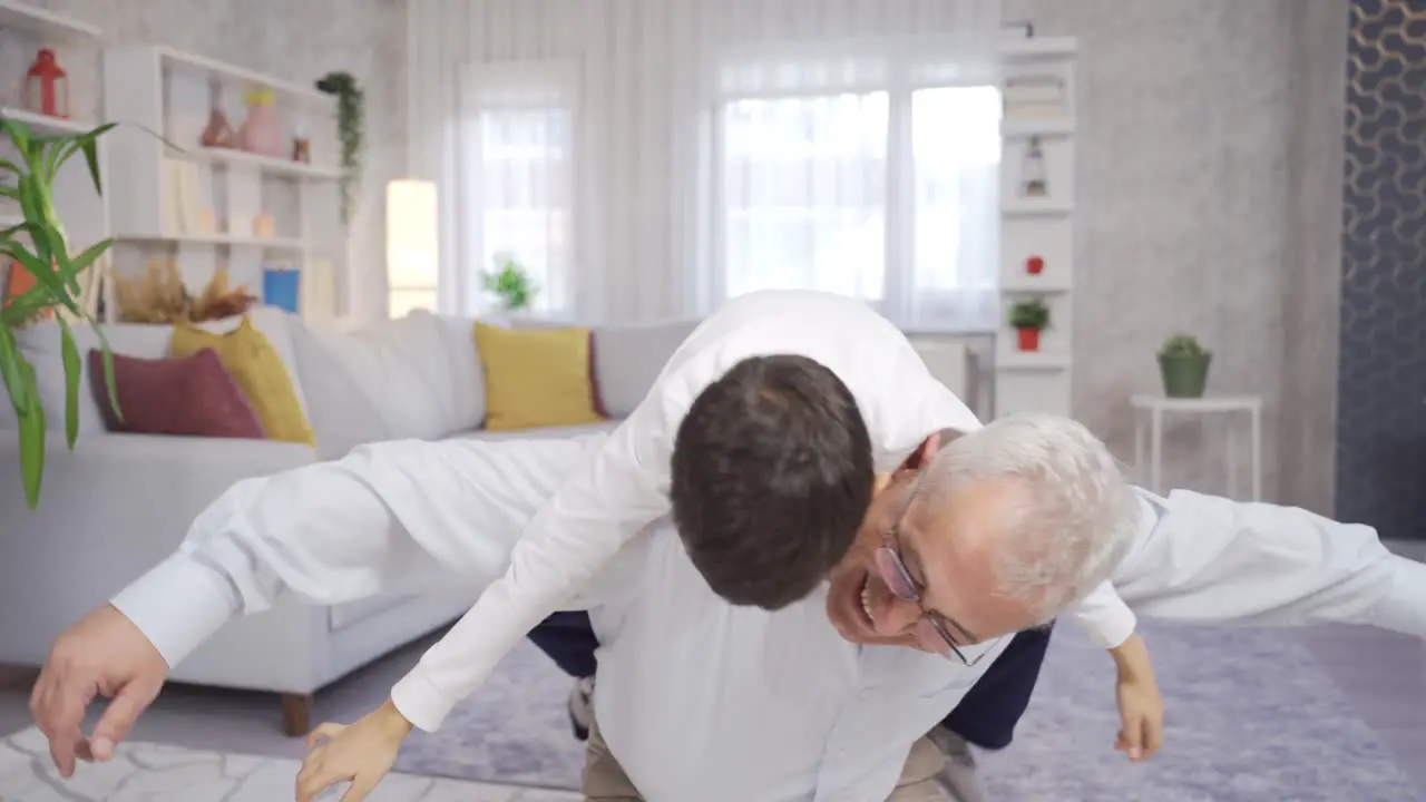 Father and son are having fun at home playing games