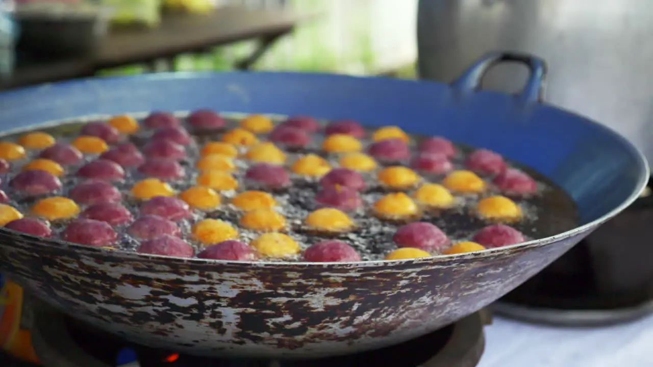 Fried food on an asian street food market filmed in slowmotion