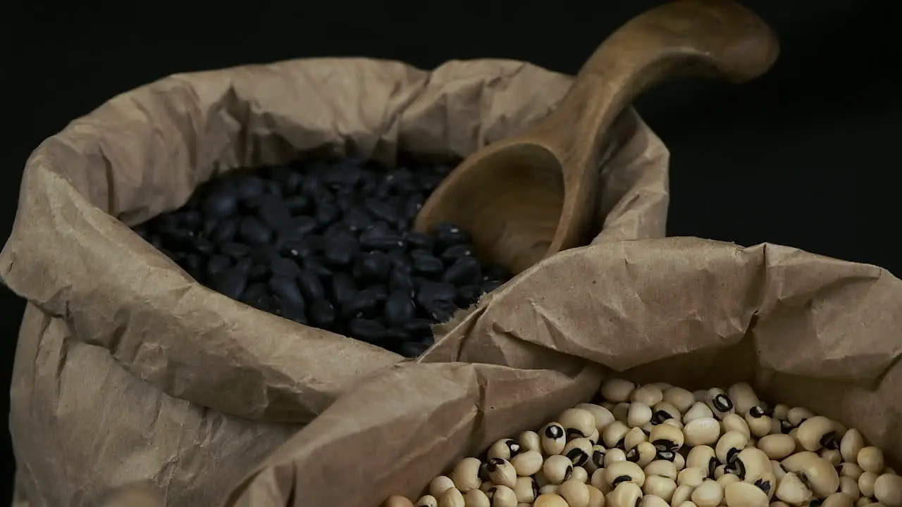 High angle view of rotating dry beans in paper bags black and white