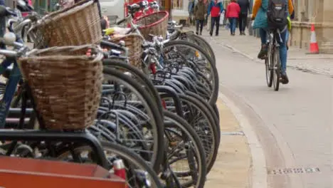 Tracking Shot Along Public Bicycle Rack On Busy Street