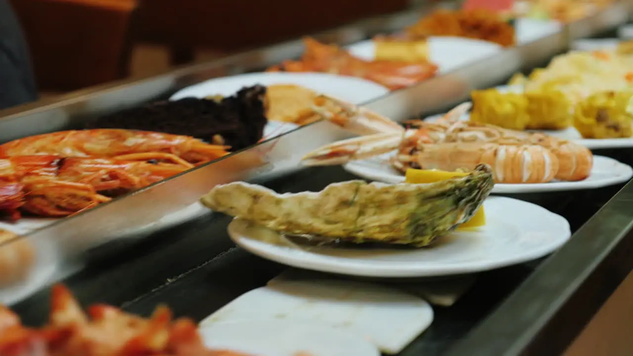 Seafood plates move on conveyor belt at All Inclusive Restaurant 1