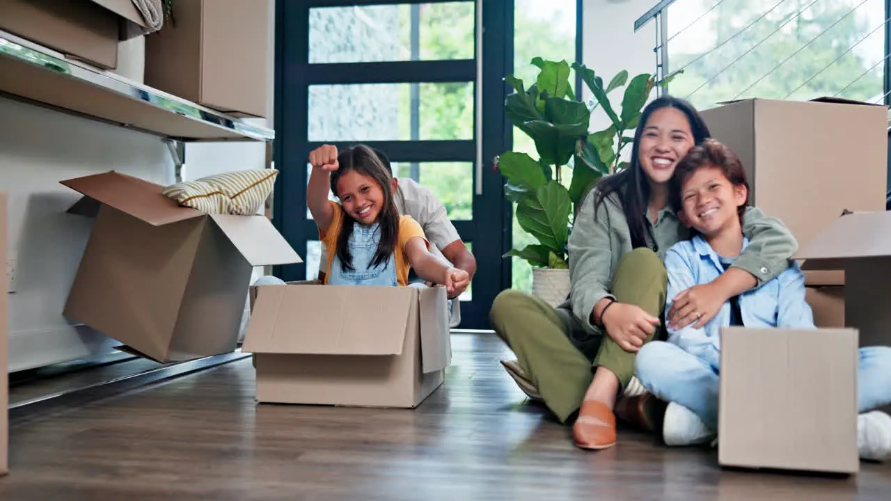 Happy family girl and playing with box in new